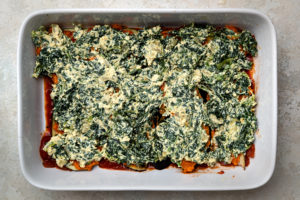 spinach and ricotta lasagna layer on top of pumpkin