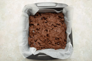 Brownie batter in lined baking tin