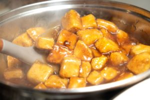 Cooked tofu stirred through teriyaki sauce