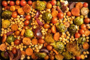 Chickpeas, tomatoes and garlic added to tray