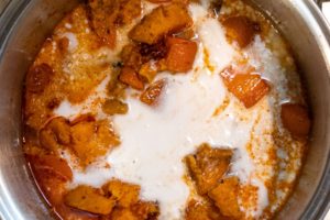 Kumara, carrot, vegetable stock and coconut milk added to pot