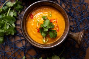 Spiced Kumara and Carrot Soup in a bowl with sliced chilli and coriander